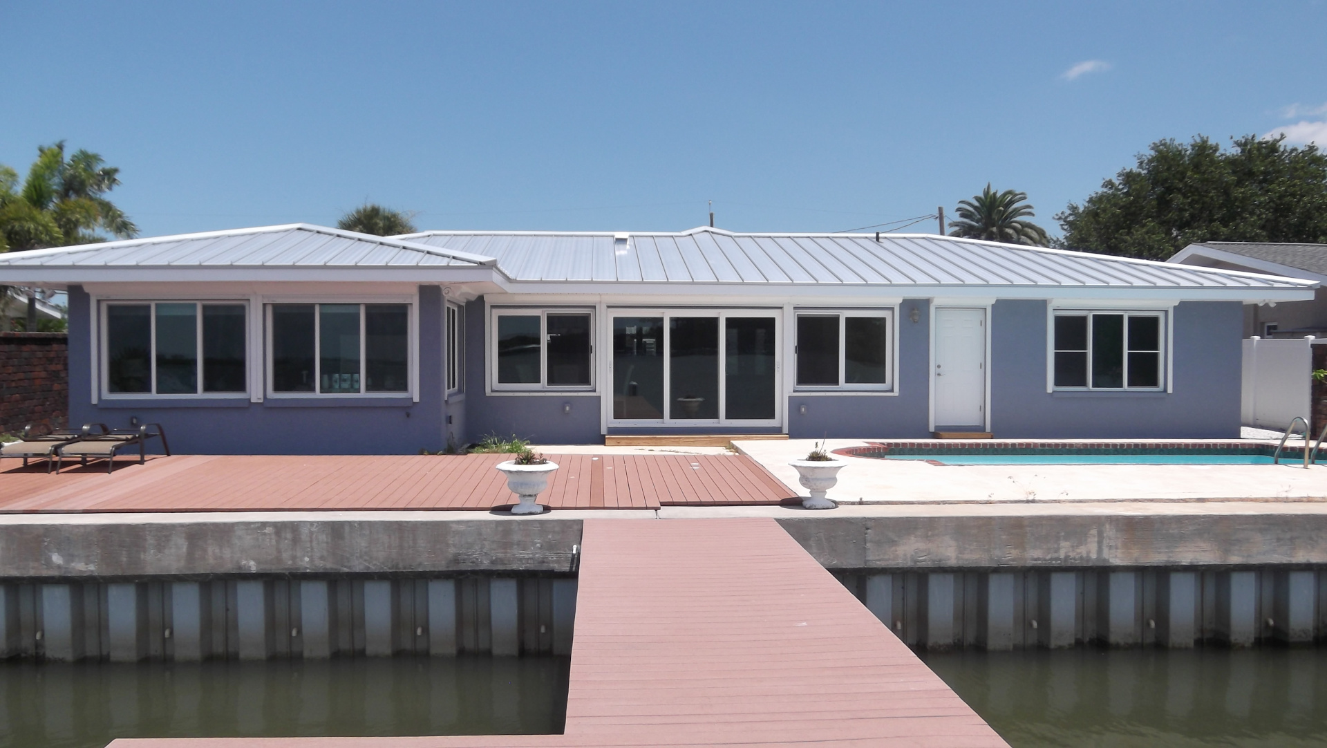 Renovated house with impact rated sliding glass doors and windows with new metal roof