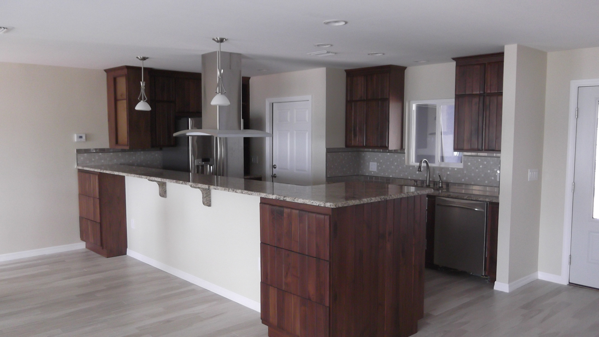 Renovated kitchen with repurposed wood cabinets and granite countertops