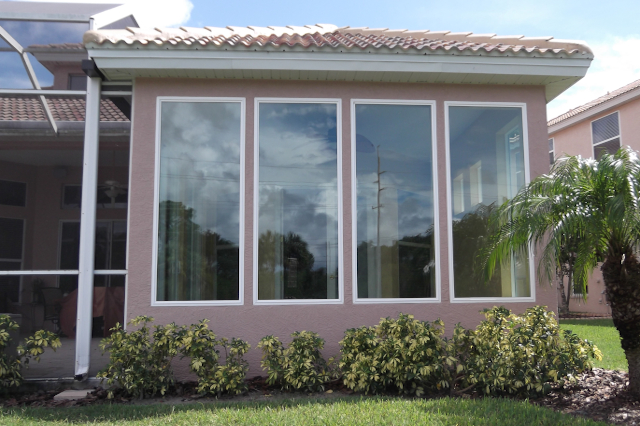 Addition Sunroom Four Picture Windows Screen Room Four white impact rated picture windows side by side on back of house addition