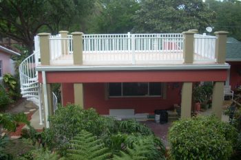 Second story balcony with spiral stairway and vinyl railings and walkable rooftop