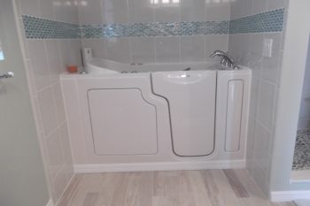 Bathroom remodel with walk-in tub next to custom shower