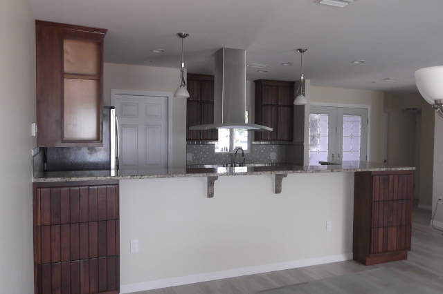 Kitchen renovation with reused cabinets and granite countertops