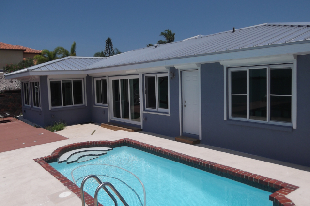 Back yard with pool, showing impact rated sliding windows and doors