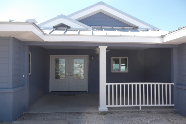 Covered entry porch with fiberglass post, vinyl railing and double entry door