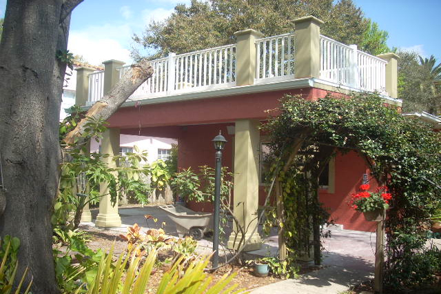 Second story balcony supported by stucco columns