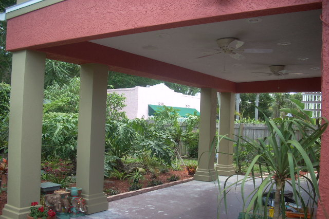 Covered patio with stucco ceiling and columns over concrete deck