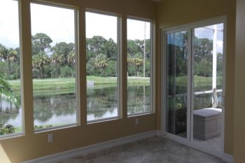 Impact rated picture windows with view of pond and golf course